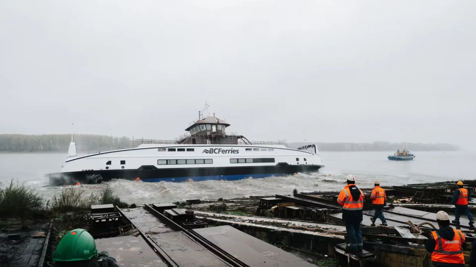 BC Ferries Island Class 8117 E3 hybrid road ferry launched at Damen Shipyards Galați, Damen crew in safety gear watching from the quayside.