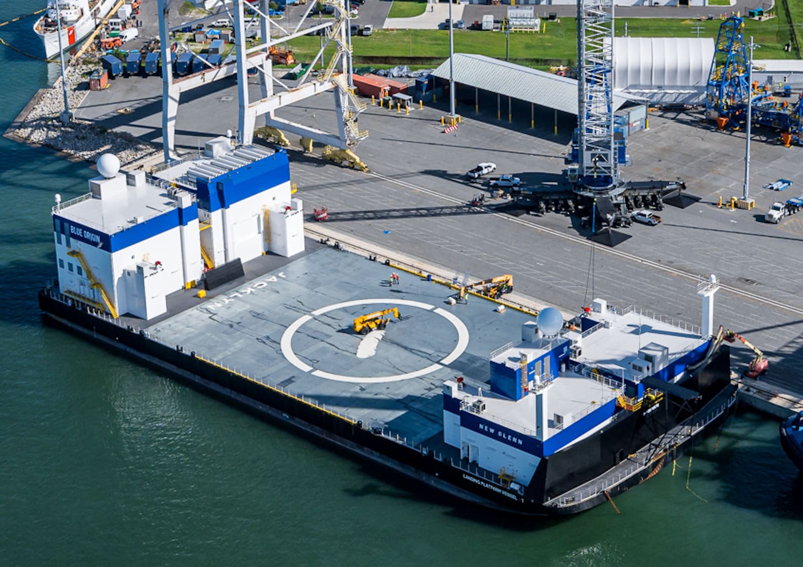 Blue Origin Jacklyn landing platform recovery barge with central helipad markings, docked at Damen Shiprepair Brest.