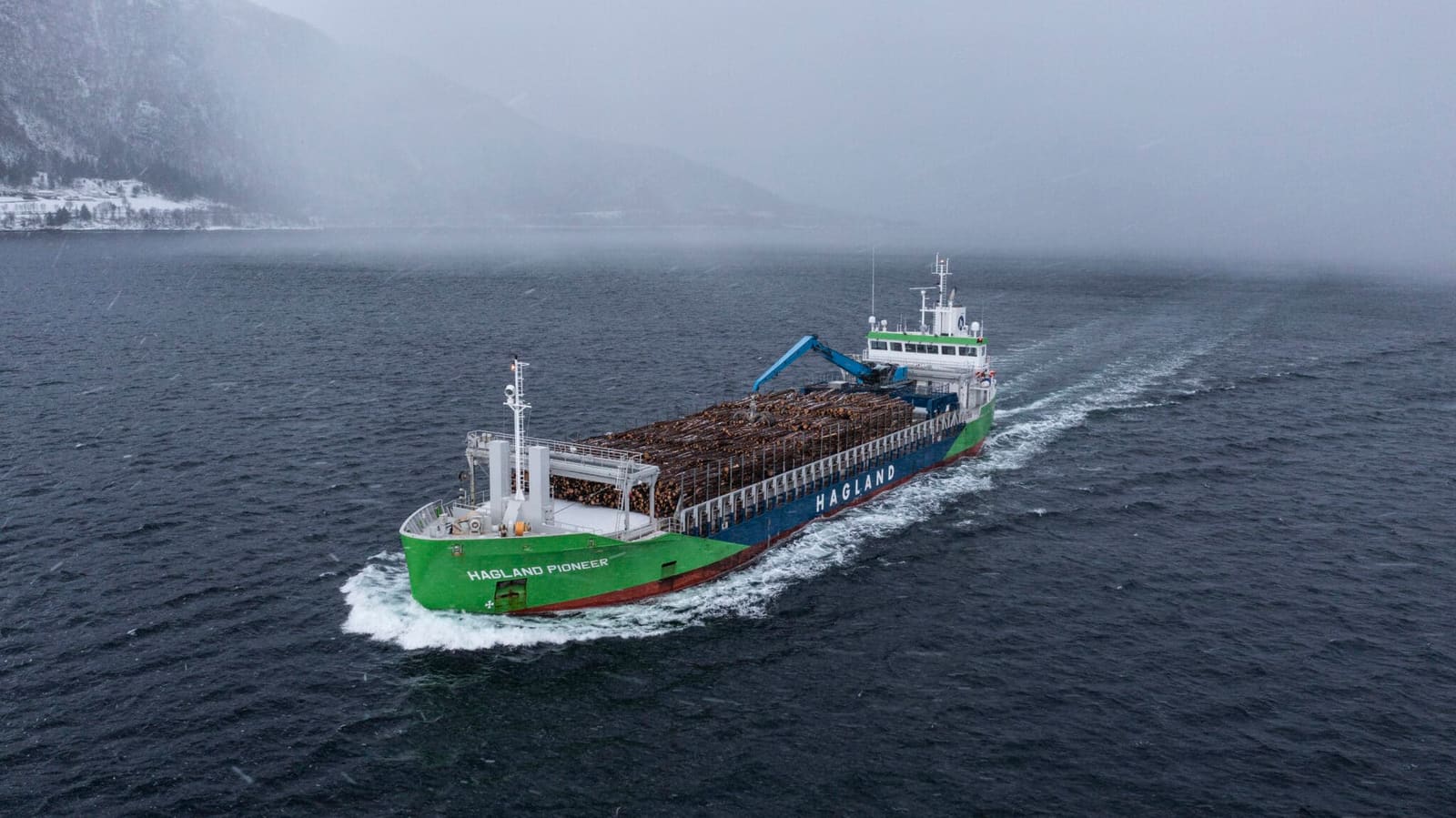 Hagland Pioneer hybrid general cargo vessel of the Pioneer/Progress/Premier series transiting a Norwegian fjord loaded with timber.