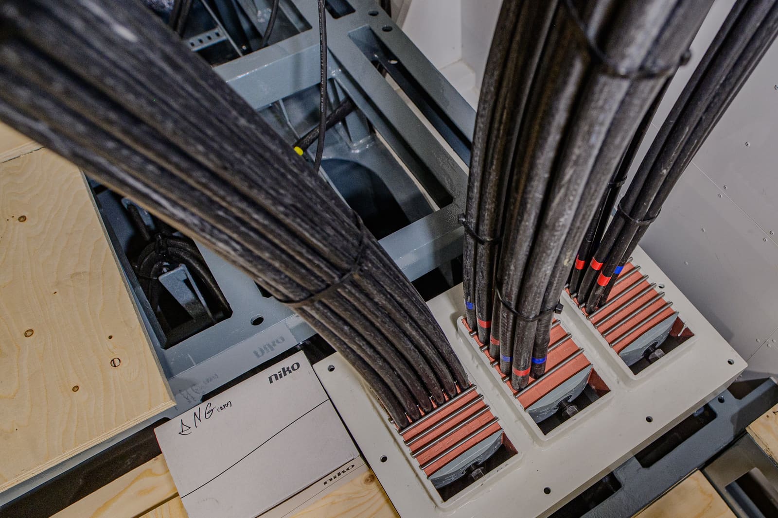 Heavy-section marine power cables entering a transit penetration frame with brick-style multi-cable transit blocks