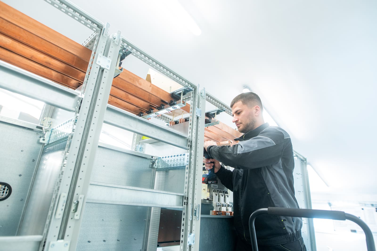 Black Frog Elektro panel builder securing copper busbar runs at the top of a marine main switchboard frame