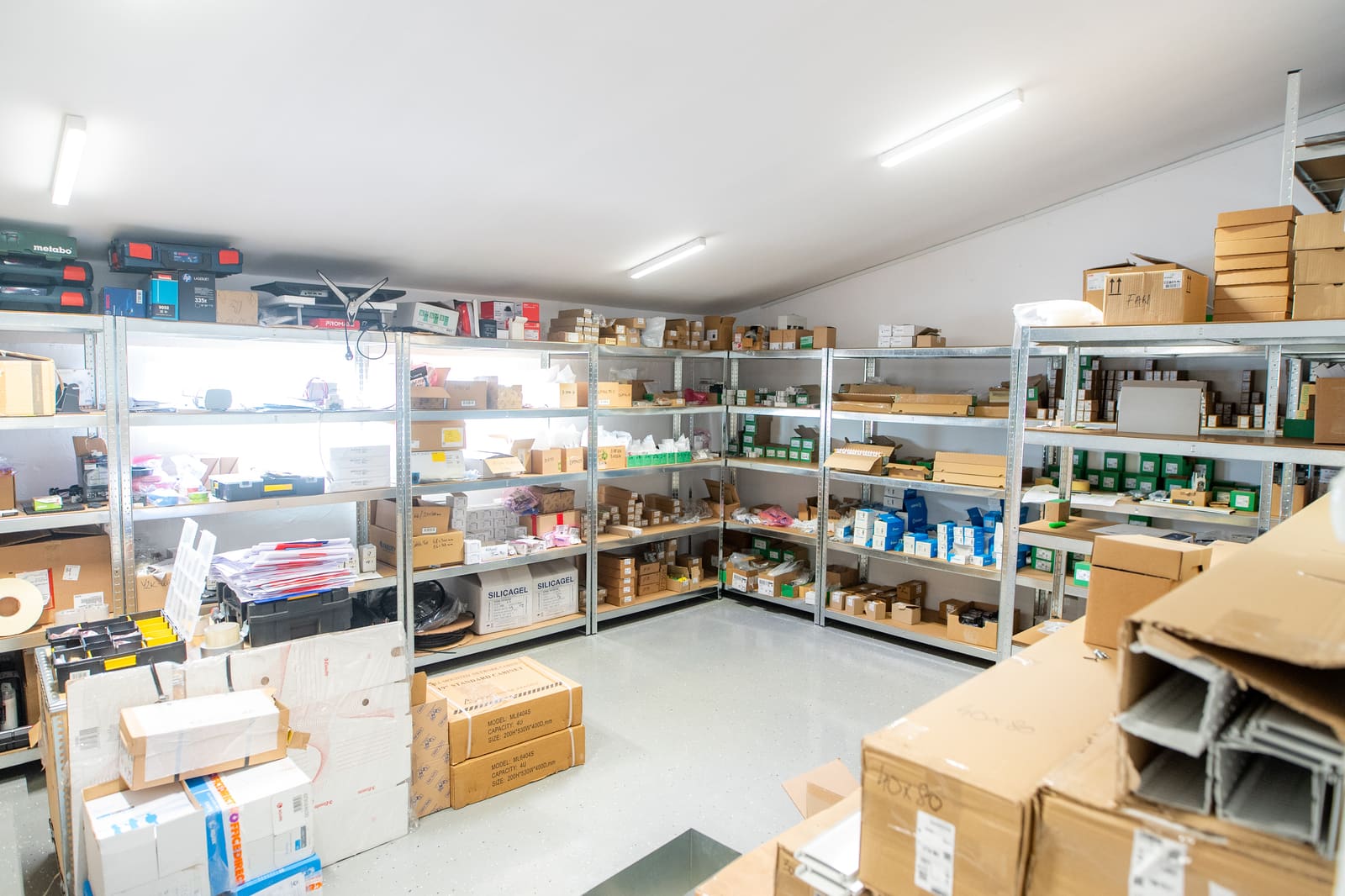 Black Frog Elektro panel-building store with shelving organised by component type and packed materials ready for production