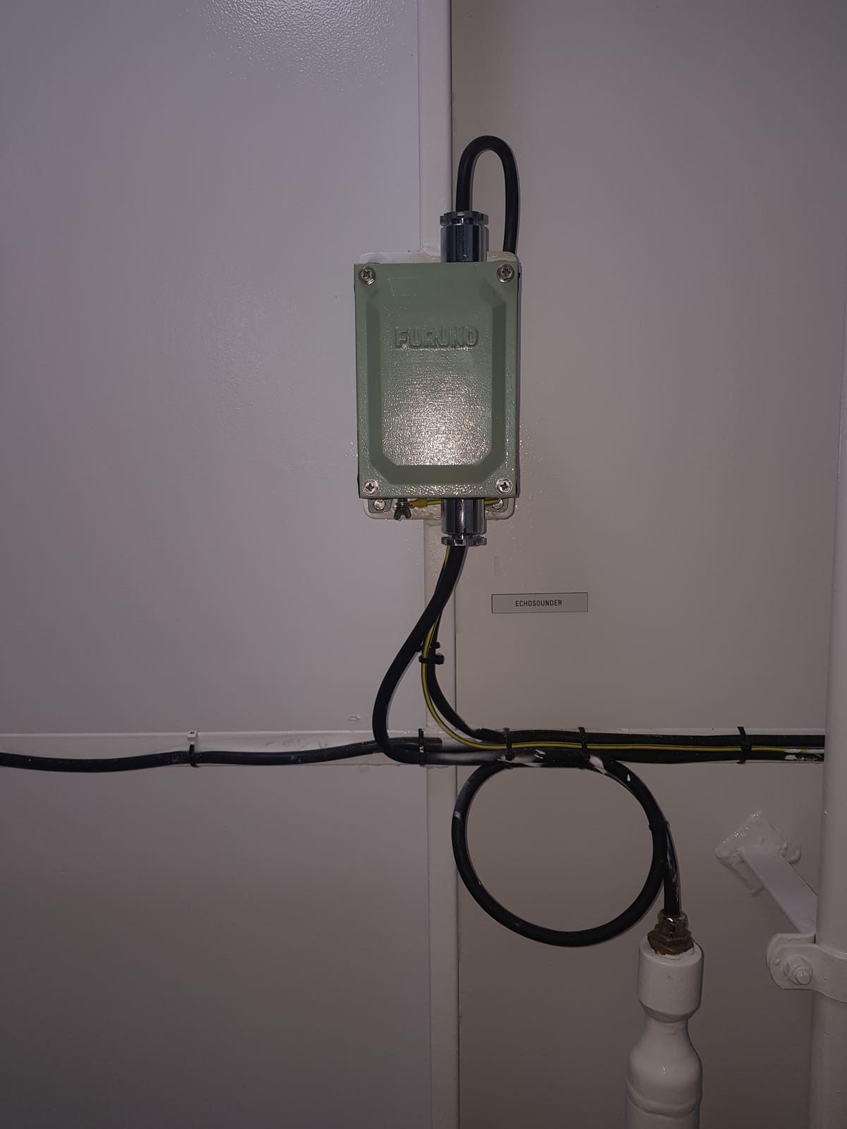IP-rated junction box installed on a bulkhead with marine cables routed in through cable glands