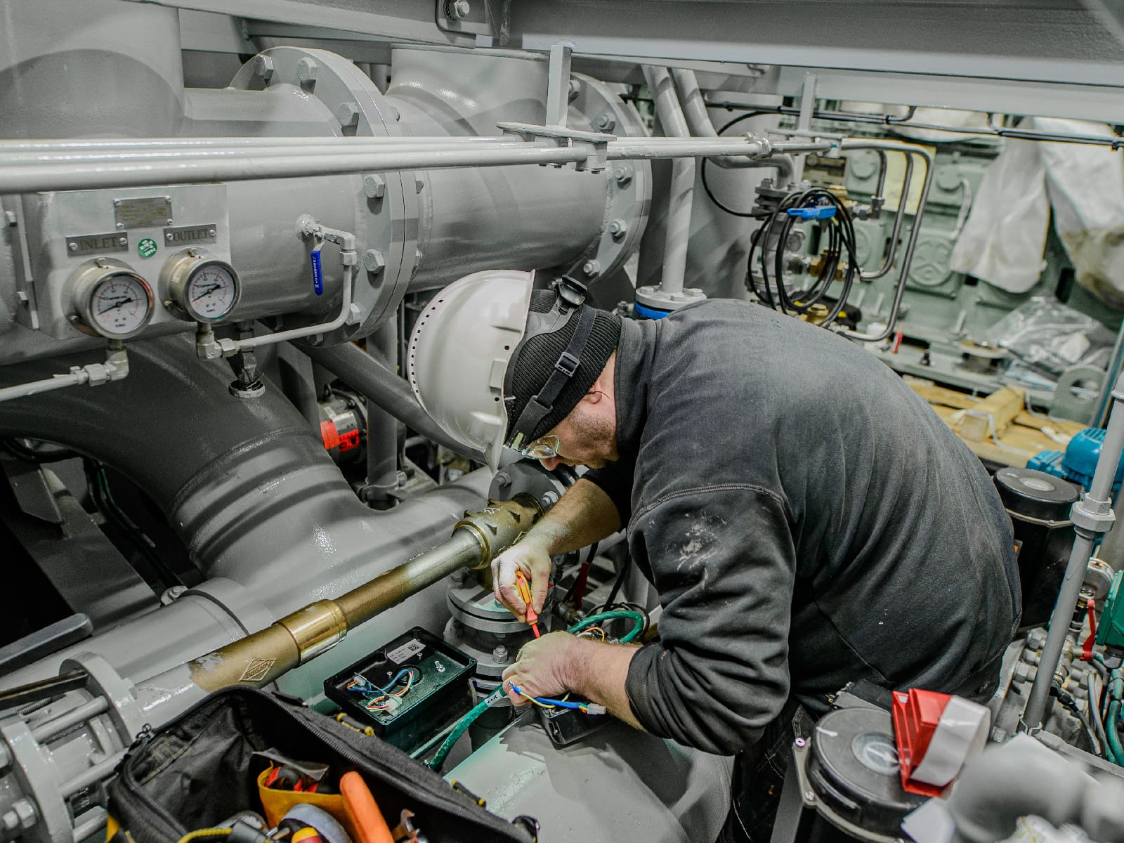 Technician performing maintenance work during a vessel refit.