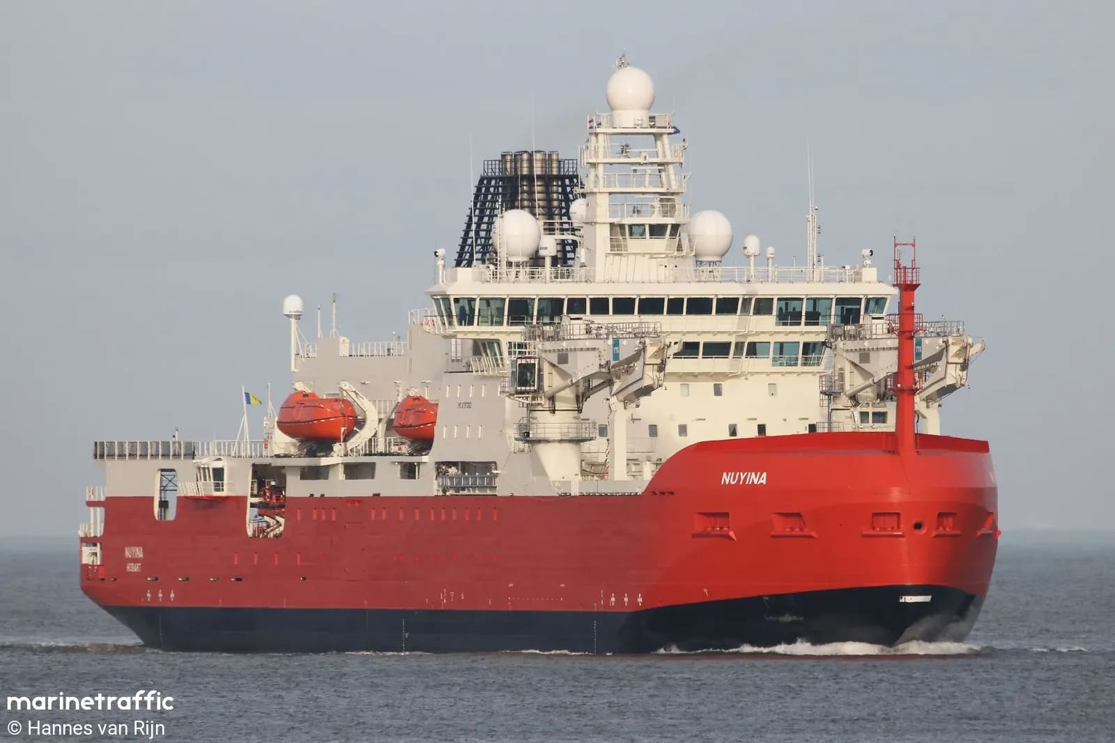 Research and Supply Vessel RSV Nuyina at sea, red hull with white multi-deck superstructure and radar domes, built at Damen Galați and Damen Vlissingen for the Australian Antarctic Division.