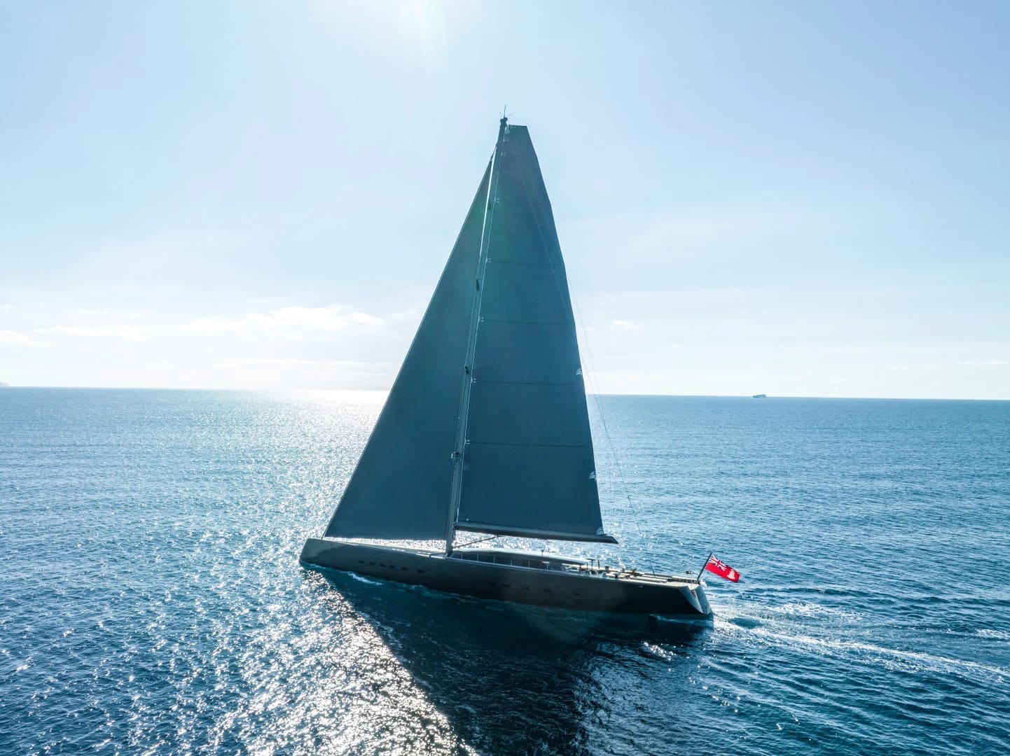 Modern sloop-rigged sailing yacht under sail at sea, built at Vitters Shipyard, Zwartsluis, Red Ensign at the stern.